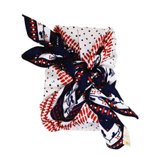 Colourful silk scarf in red, white and blue, wrapped around a College Green gift box tied in a bow