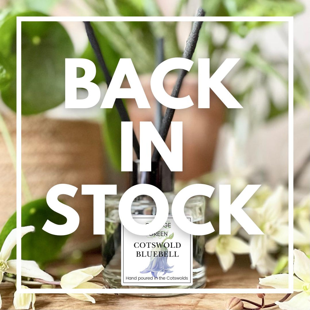 College Green Cotswold Bluebell reed diffuser surrounded by flowers. Back in stock