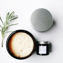 Three jars of College Green Sleep Easy bath soak with lavender and valerian viewed from above. One jar is open, showing contents. one jar shows silver lid, the third is laying on its side showing the white label. Sprig of lavender.